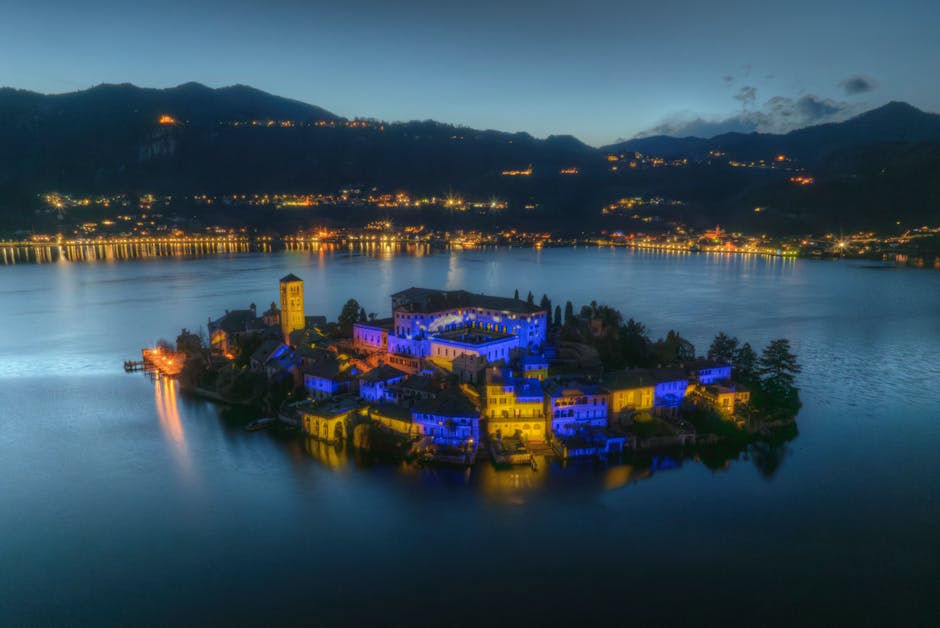 Aerial view of San Giulio Island at twilight, beautifully illuminated over Lake Orta in Italy